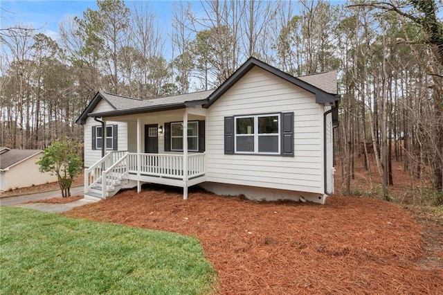 view of front of home featuring covered porch and a front yard