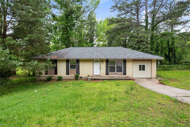 ranch-style house with brick siding, a front lawn, and a shingled roof