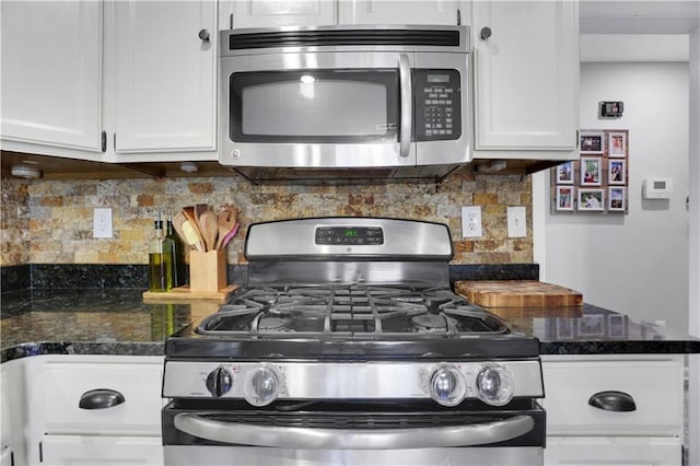 kitchen with appliances with stainless steel finishes, white cabinetry, and tasteful backsplash