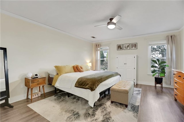 bedroom featuring ornamental molding, ceiling fan, and hardwood / wood-style floors