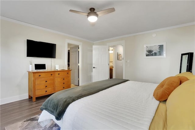 bedroom with ensuite bathroom, ceiling fan, hardwood / wood-style flooring, and crown molding