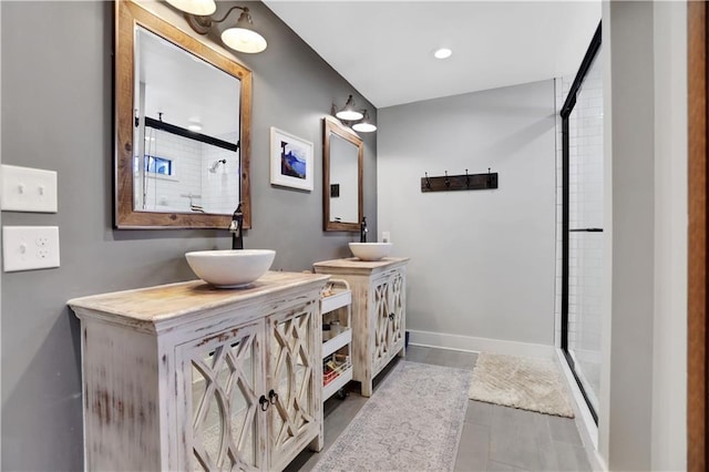 bathroom with a shower with door and vanity