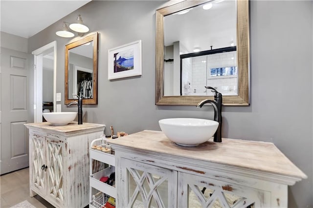 bathroom with a shower with door and vanity