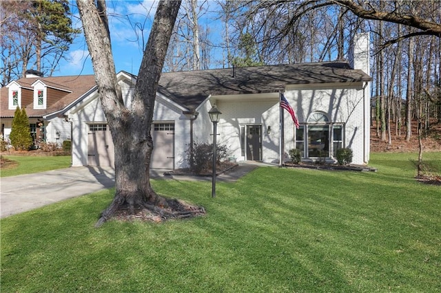 view of front of property with a front lawn and a garage