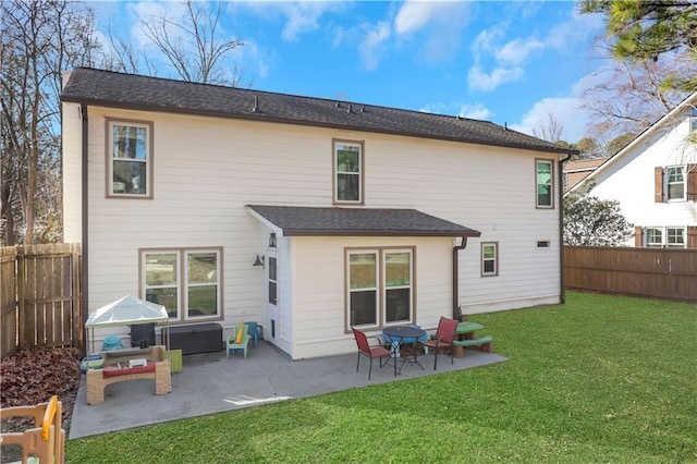 back of house featuring a lawn and a patio area