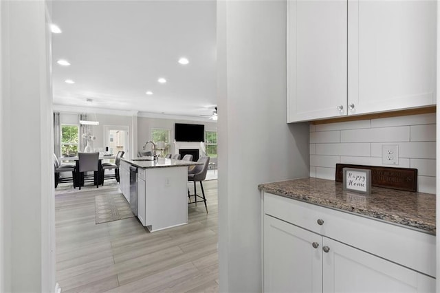 140 Canyons Ct, Hampton, GA 30228 - kitchen with recessed lighting, ceiling fan, white cabinets, a fireplace, and open floor plan