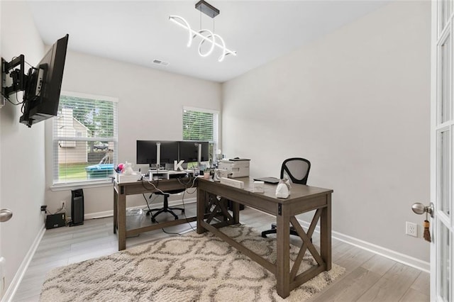 140 Canyons Ct, Hampton, GA 30228 - office area featuring plenty of natural light, wood finished floors, and a chandelier
