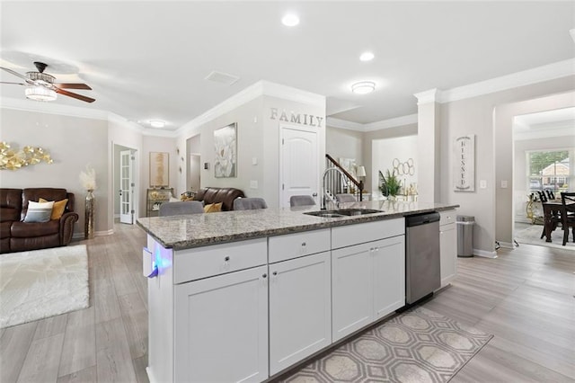 140 Canyons Ct, Hampton, GA 30228 - kitchen with dishwasher, open floor plan, light stone counters, ceiling fan, and an island with sink