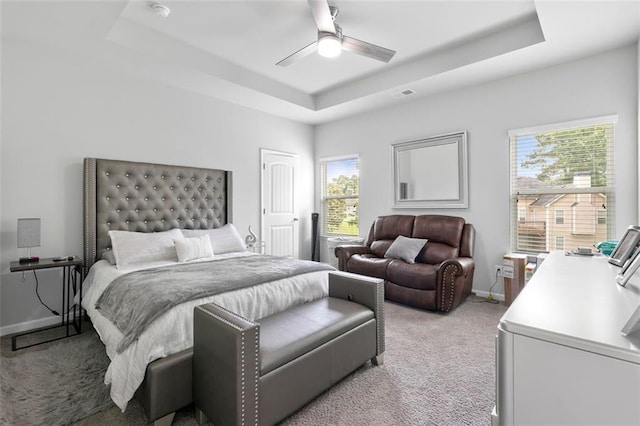 140 Canyons Ct, Hampton, GA 30228 - bedroom featuring a raised ceiling, light carpet, multiple windows, and ceiling fan