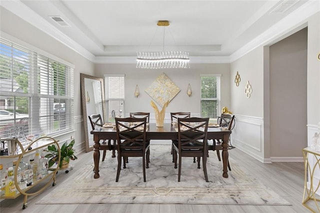 140 Canyons Ct, Hampton, GA 30228 - dining space featuring a chandelier, a raised ceiling, wood finished floors, and wainscoting