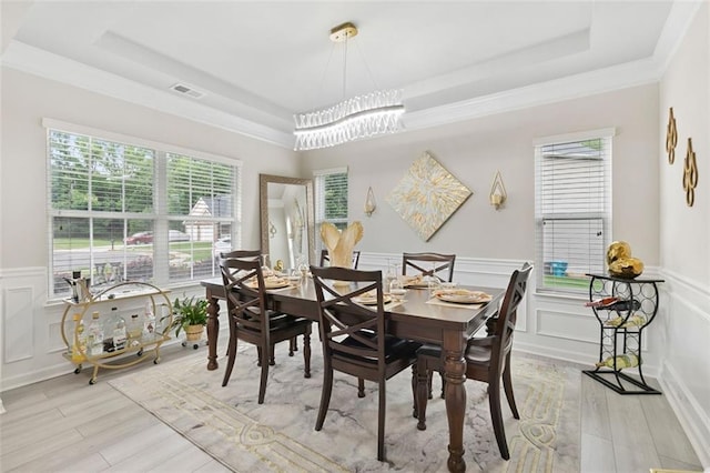 140 Canyons Ct, Hampton, GA 30228 - dining space with a tray ceiling, light wood-type flooring, a decorative wall, healthy amount of natural light, and wainscoting