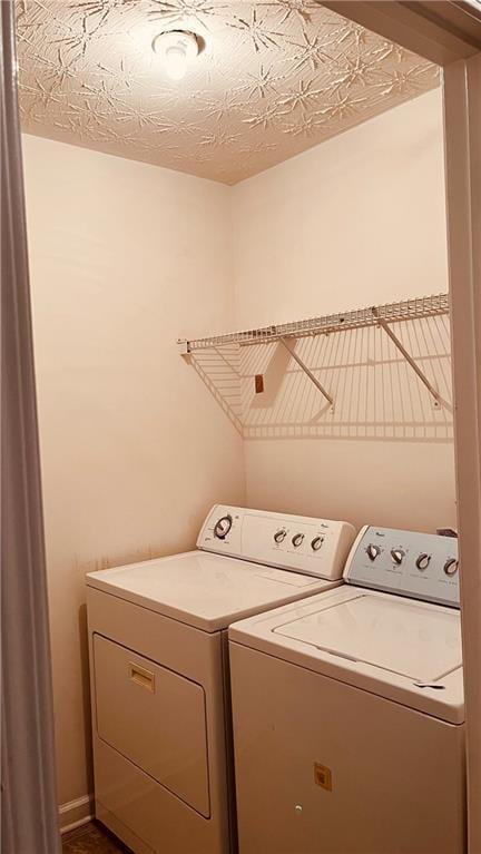 clothes washing area with independent washer and dryer and laundry area