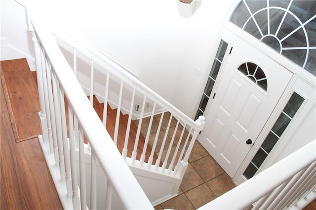 stairway with tile patterned floors