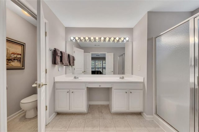 full bathroom featuring a sink, a shower stall, and double vanity