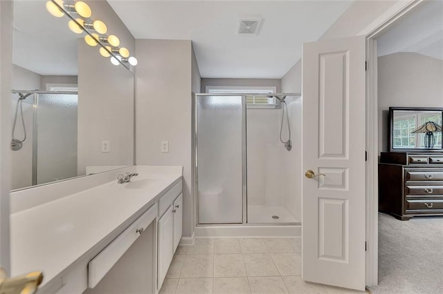 bathroom featuring a stall shower, vanity, visible vents, and tile patterned floors