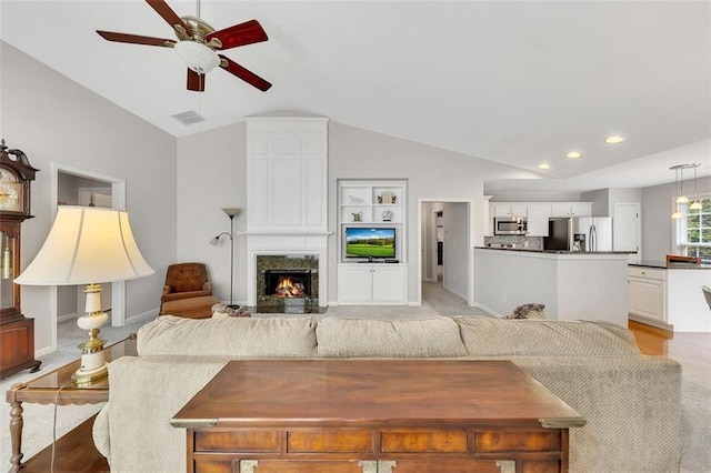 living area with a fireplace, lofted ceiling, recessed lighting, visible vents, and a ceiling fan