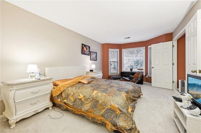 bedroom with light colored carpet