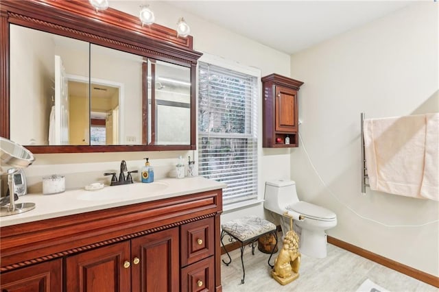 bathroom featuring vanity and toilet