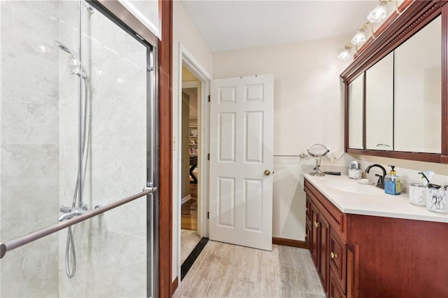 bathroom featuring vanity, wood-type flooring, and walk in shower