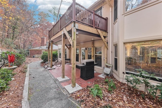 view of patio with area for grilling and a balcony