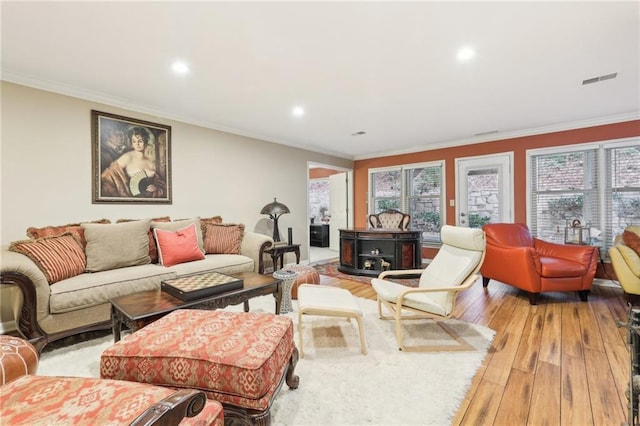 living room featuring light hardwood / wood-style floors and crown molding