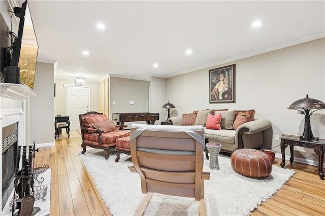 living room with light hardwood / wood-style floors and crown molding