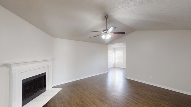 unfurnished living room with ceiling fan, lofted ceiling, wood-type flooring, and a textured ceiling