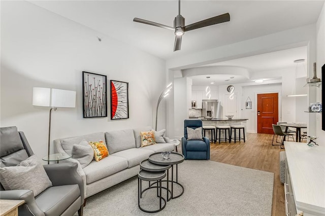 200 River Vista Dr Unit 713, Atlanta, GA 30339 - living room with arched walkways, wood finished floors, and ceiling fan