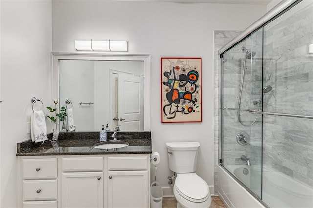 200 River Vista Dr Unit 713, Atlanta, GA 30339 - bathroom with toilet, vanity, baseboards, and bath / shower combo with glass door