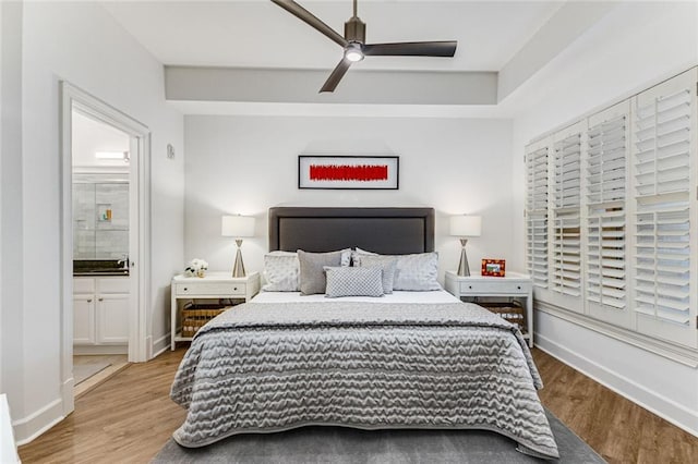 200 River Vista Dr Unit 713, Atlanta, GA 30339 - bedroom featuring baseboards, a ceiling fan, ensuite bath, and wood finished floors