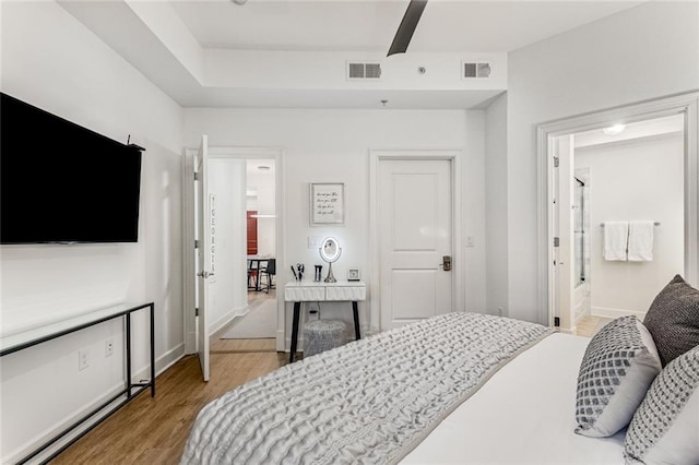 200 River Vista Dr Unit 713, Atlanta, GA 30339 - bedroom featuring light wood-type flooring, baseboards, visible vents, and connected bathroom