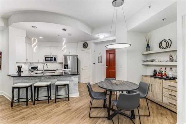 200 River Vista Dr Unit 713, Atlanta, GA 30339 - dining space with visible vents, light wood-type flooring, and baseboards