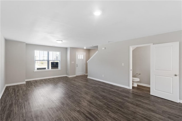 unfurnished living room featuring baseboards, dark wood-style floors, and recessed lighting