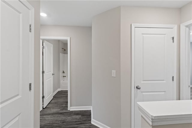 hallway with baseboards, dark wood-style flooring, and recessed lighting