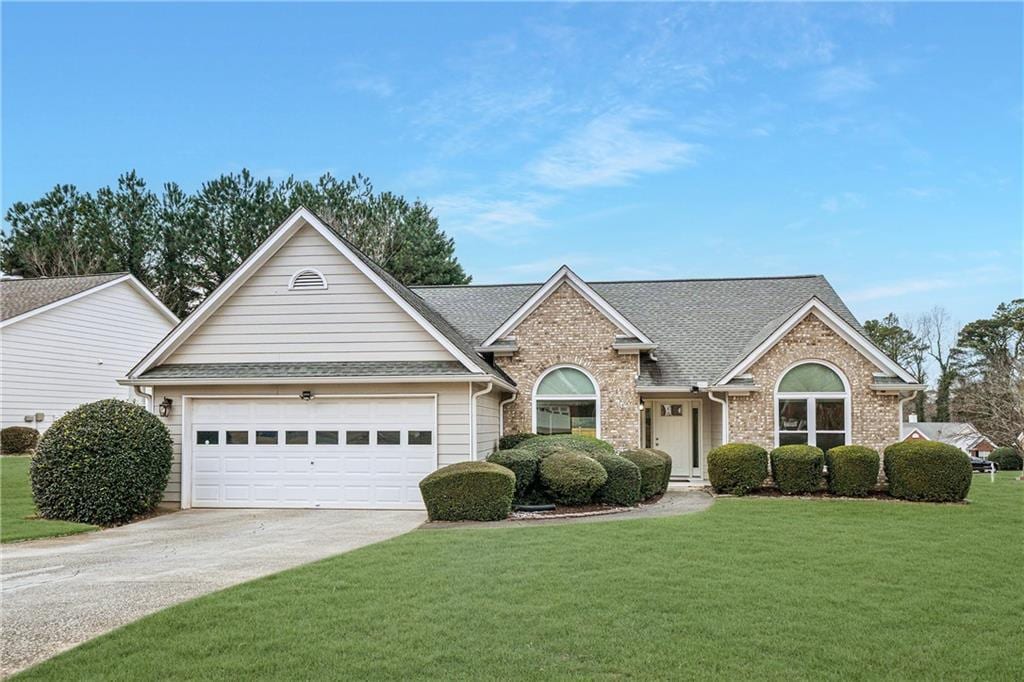 view of front of home featuring a garage and a front lawn