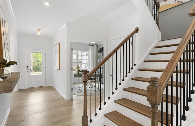 4317 Azalea Ridge Way, Hoschton, GA 30548 - foyer entrance with light wood-style flooring, stairs, and ornamental molding