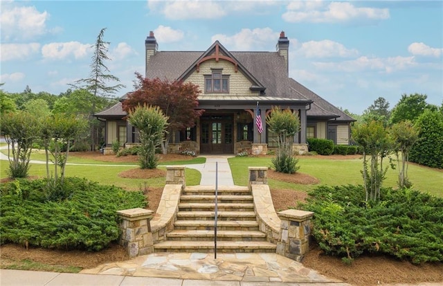 4317 Azalea Ridge Way, Hoschton, GA 30548 - view of front of home with french doors, a front yard, covered porch, stone siding, and a chimney