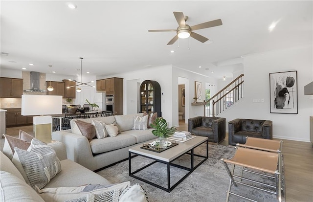 4317 Azalea Ridge Way, Hoschton, GA 30548 - living room featuring stairway, recessed lighting, a ceiling fan, wood finished floors, and crown molding
