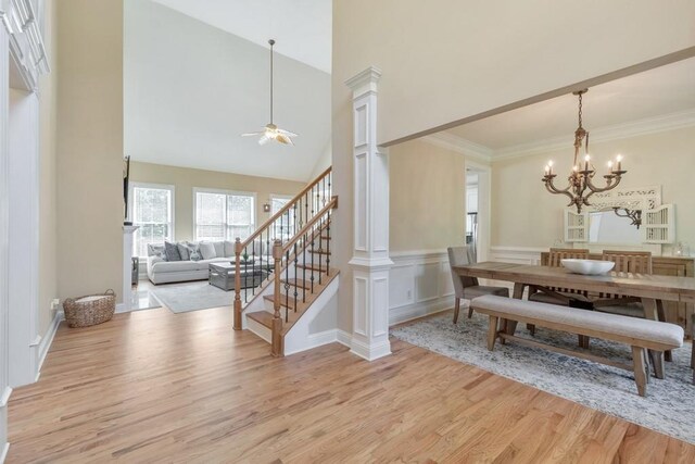 4621 Chartwell Chase Ct, Flowery Branch, GA 30542 - dining room with light wood-style floors, ceiling fan, decorative columns, a chandelier, and stairway