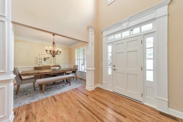 4621 Chartwell Chase Ct, Flowery Branch, GA 30542 - entryway featuring light wood-style floors, healthy amount of natural light, a chandelier, ornate columns, and crown molding