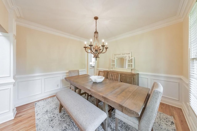 4621 Chartwell Chase Ct, Flowery Branch, GA 30542 - dining area featuring a chandelier, crown molding, light wood finished floors, a wainscoted wall, and a decorative wall