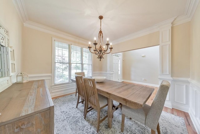 4621 Chartwell Chase Ct, Flowery Branch, GA 30542 - dining space featuring a chandelier, ornamental molding, a decorative wall, light wood-style floors, and wainscoting