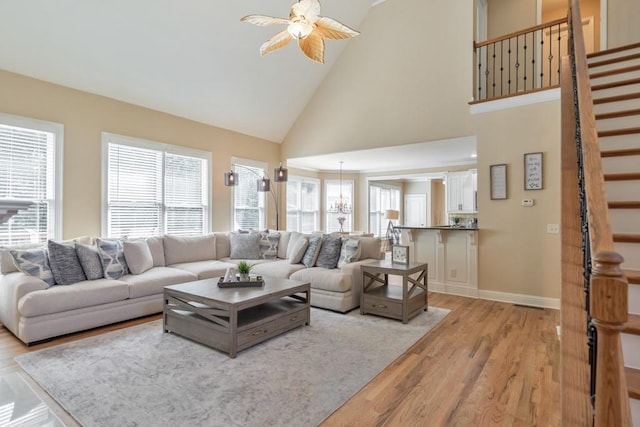 4621 Chartwell Chase Ct, Flowery Branch, GA 30542 - living room with stairway, light wood-style floors, high vaulted ceiling, and healthy amount of natural light