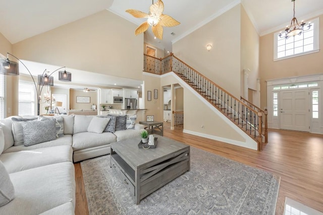4621 Chartwell Chase Ct, Flowery Branch, GA 30542 - living area with a ceiling fan, high vaulted ceiling, a chandelier, stairs, and light wood finished floors