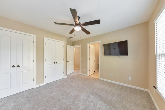 4621 Chartwell Chase Ct, Flowery Branch, GA 30542 - unfurnished bedroom with two closets, carpet, baseboards, connected bathroom, and ceiling fan