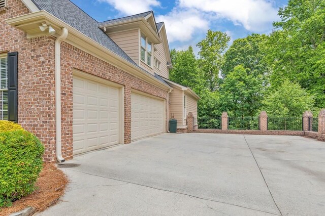 4621 Chartwell Chase Ct, Flowery Branch, GA 30542 - garage with driveway and fence