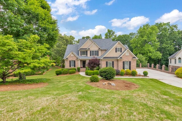4621 Chartwell Chase Ct, Flowery Branch, GA 30542 - craftsman inspired home with brick siding, a front lawn, and driveway