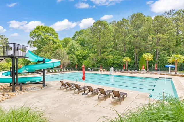 4621 Chartwell Chase Ct, Flowery Branch, GA 30542 - community pool with a water slide, a patio, fence, and view of scattered trees