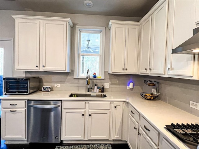 kitchen featuring tasteful backsplash, stainless steel dishwasher, sink, black gas cooktop, and white cabinetry