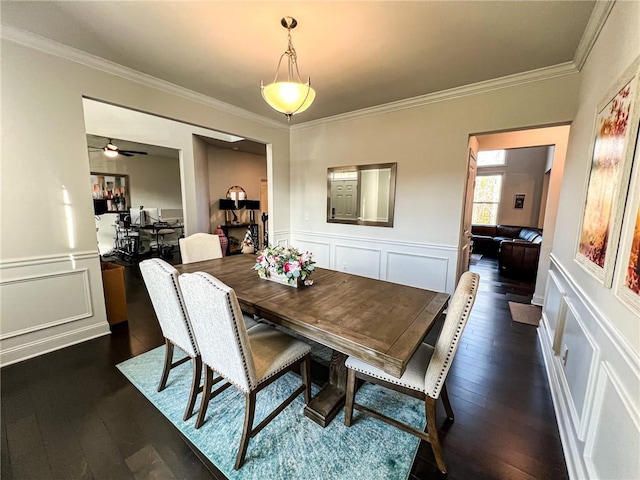 dining room with dark hardwood / wood-style floors, ceiling fan, and ornamental molding